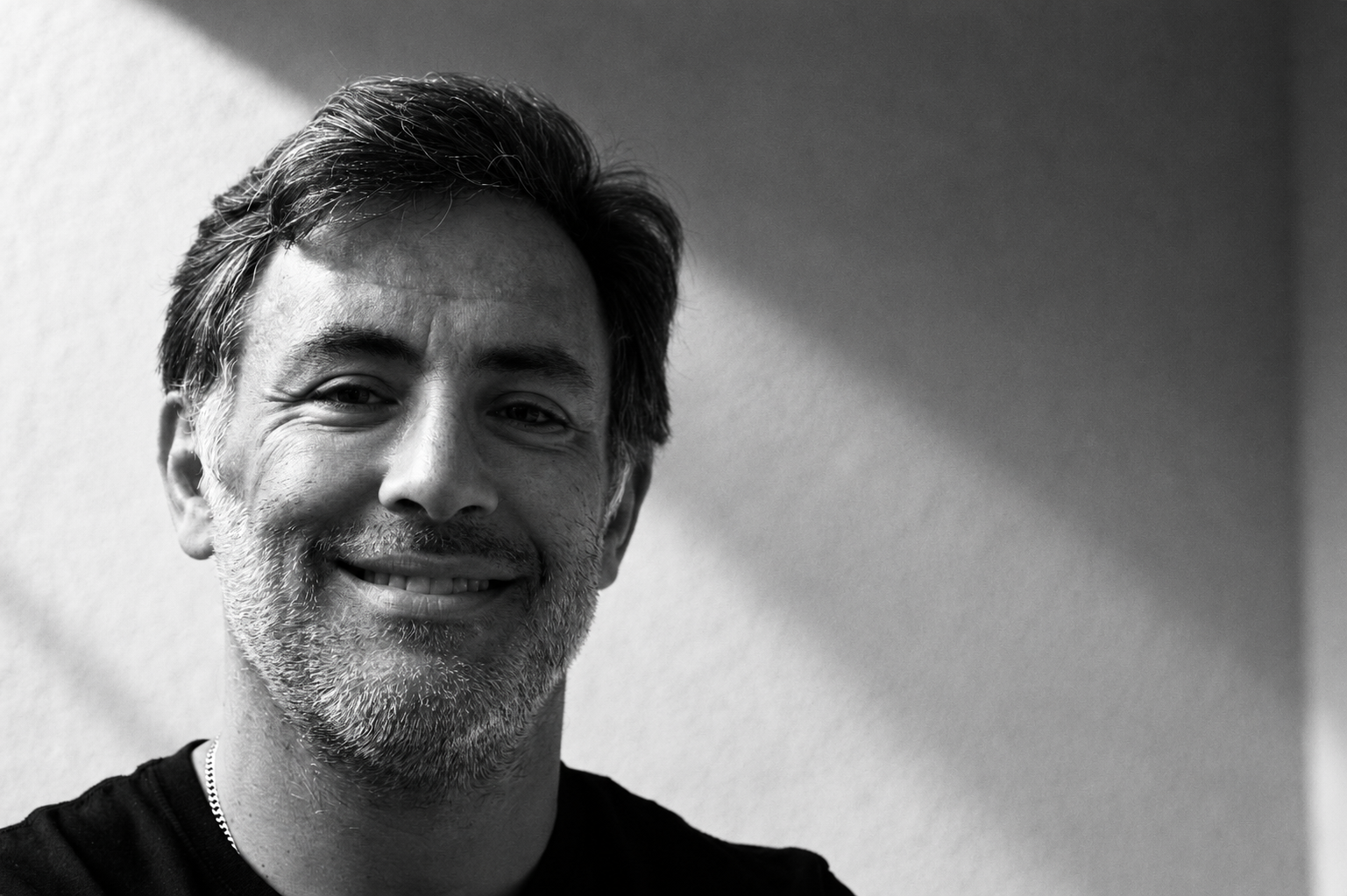Black and white portrait of João Artur Peral in directional light.